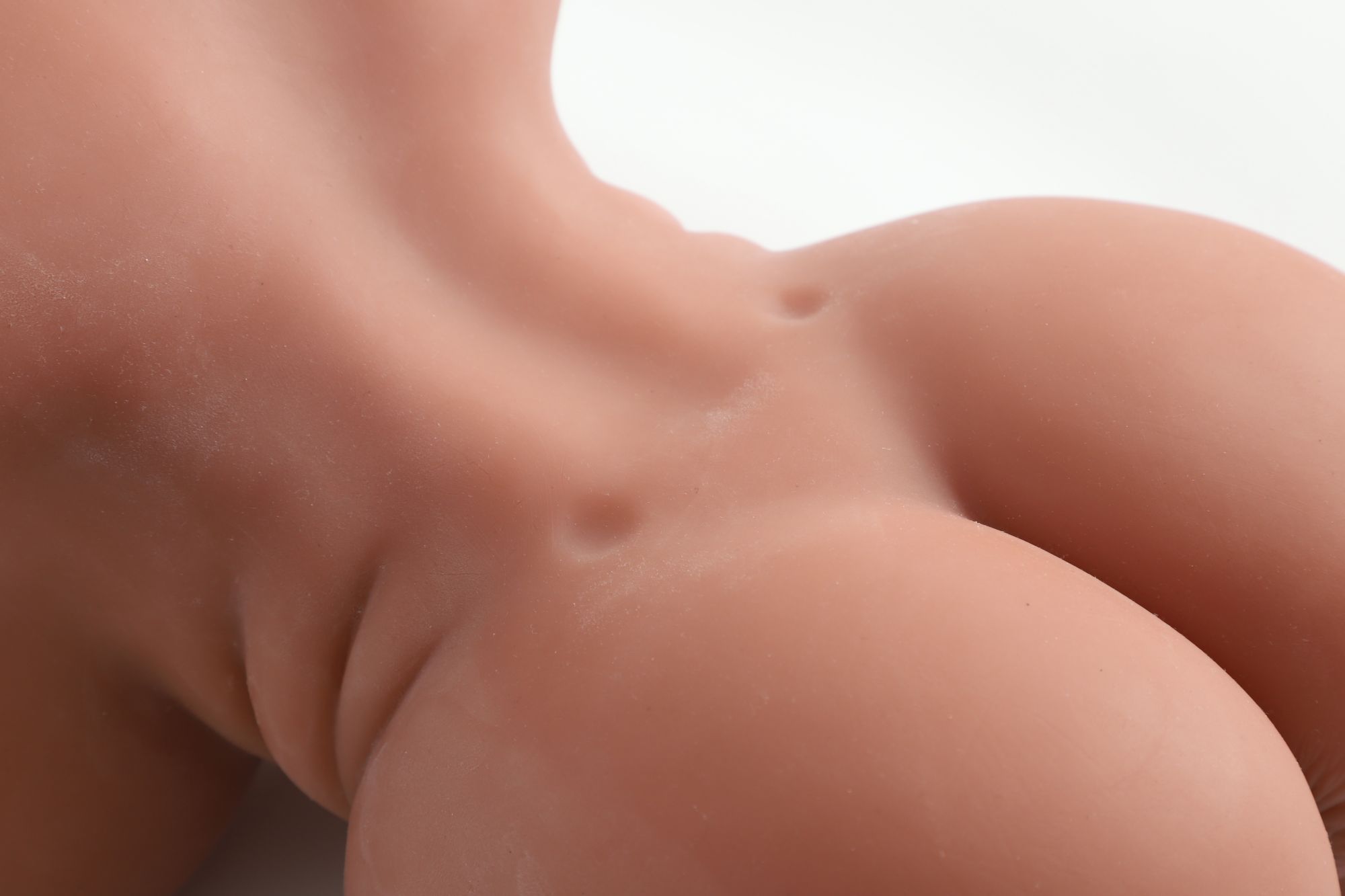 Four channel sex doll torsos7 Close-up of a sex doll torso with realistic skin texture and detailed features.